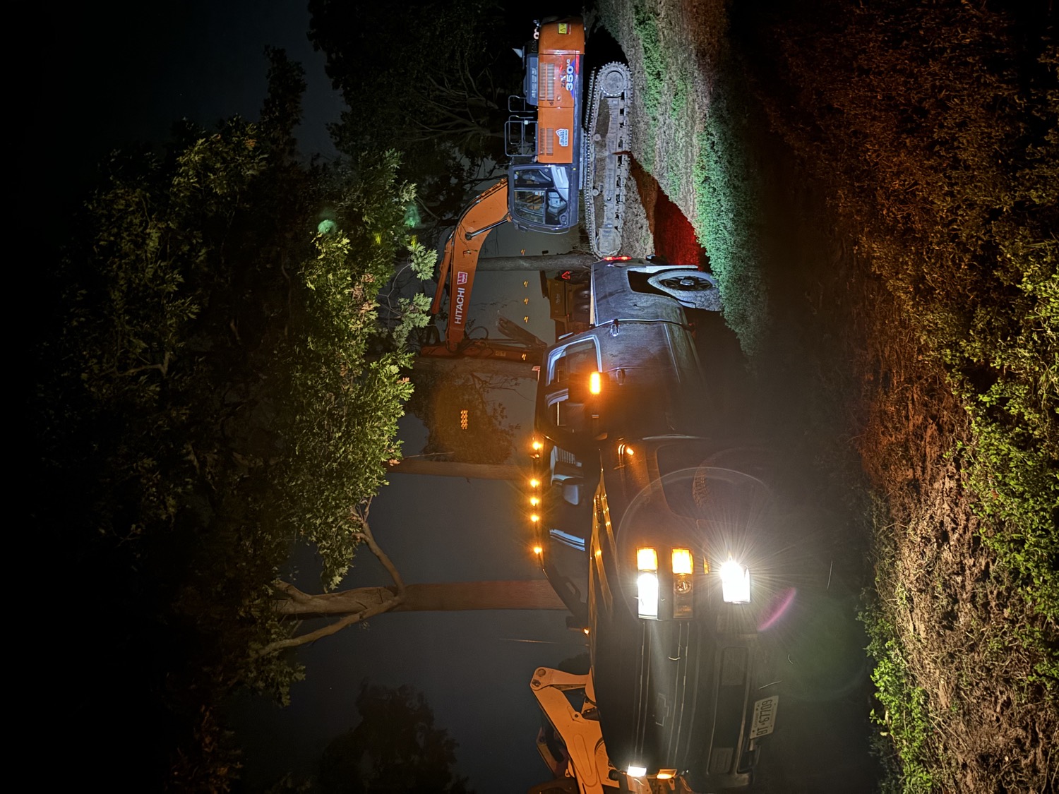 Truck and excavator working at night