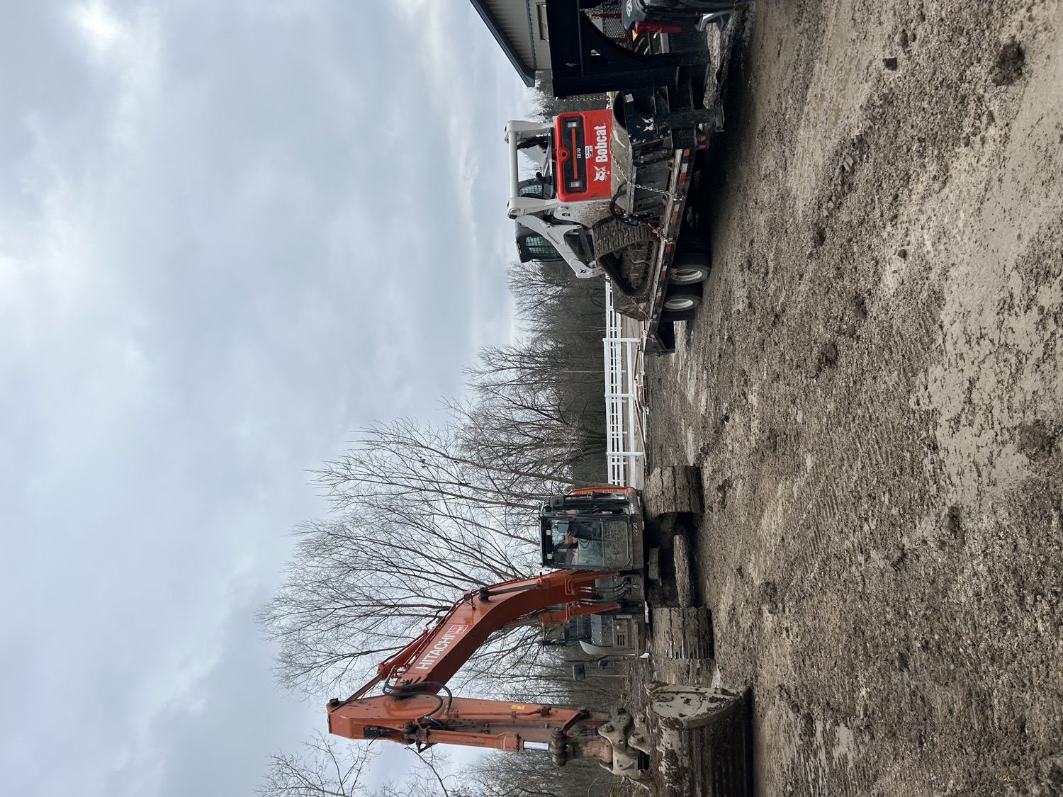 Excavator and skid steer on an excavation site