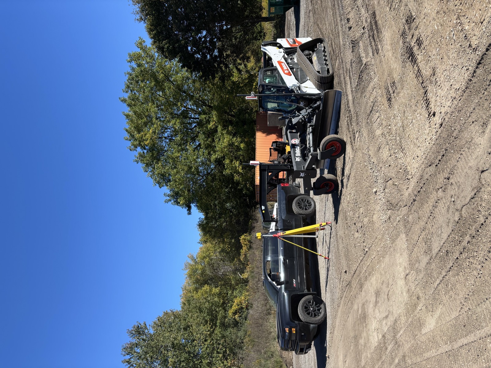 Bobcat grader and Mack truck on site