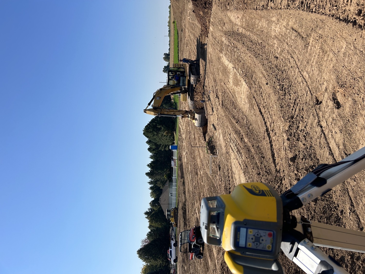 Excavator grading with laser level
