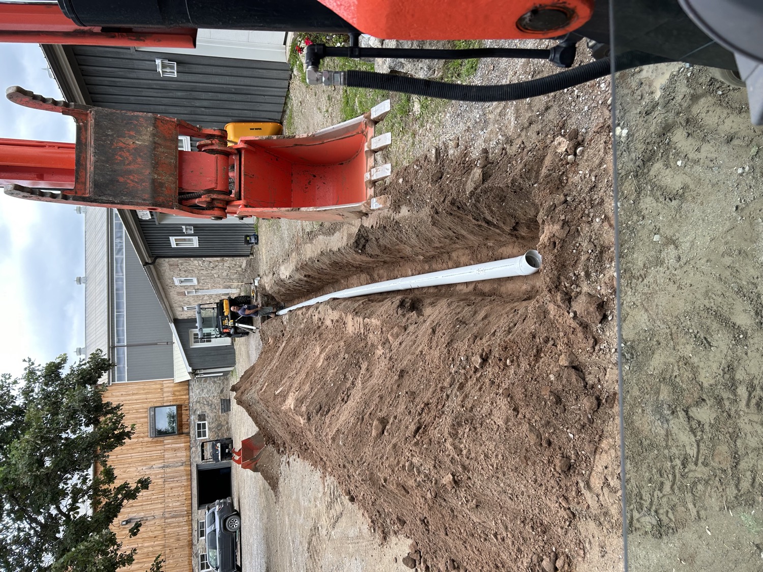 Trench and pipe beside a shop