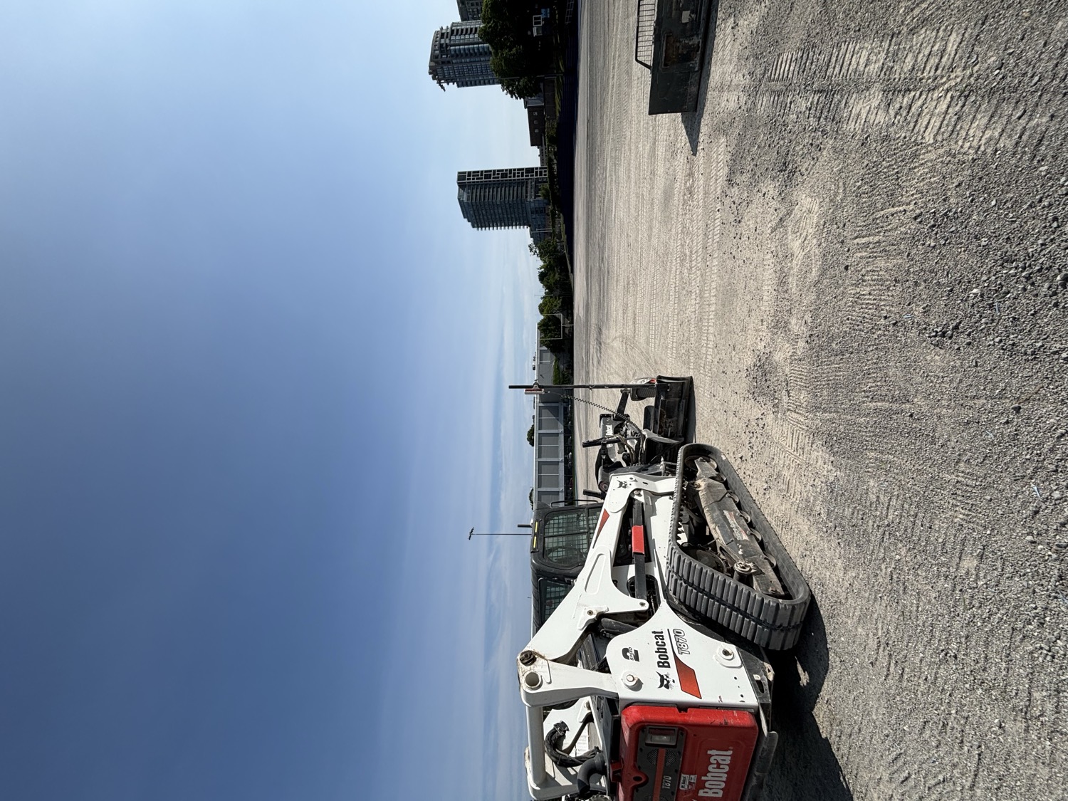 Bobcat grading a gravel lot
