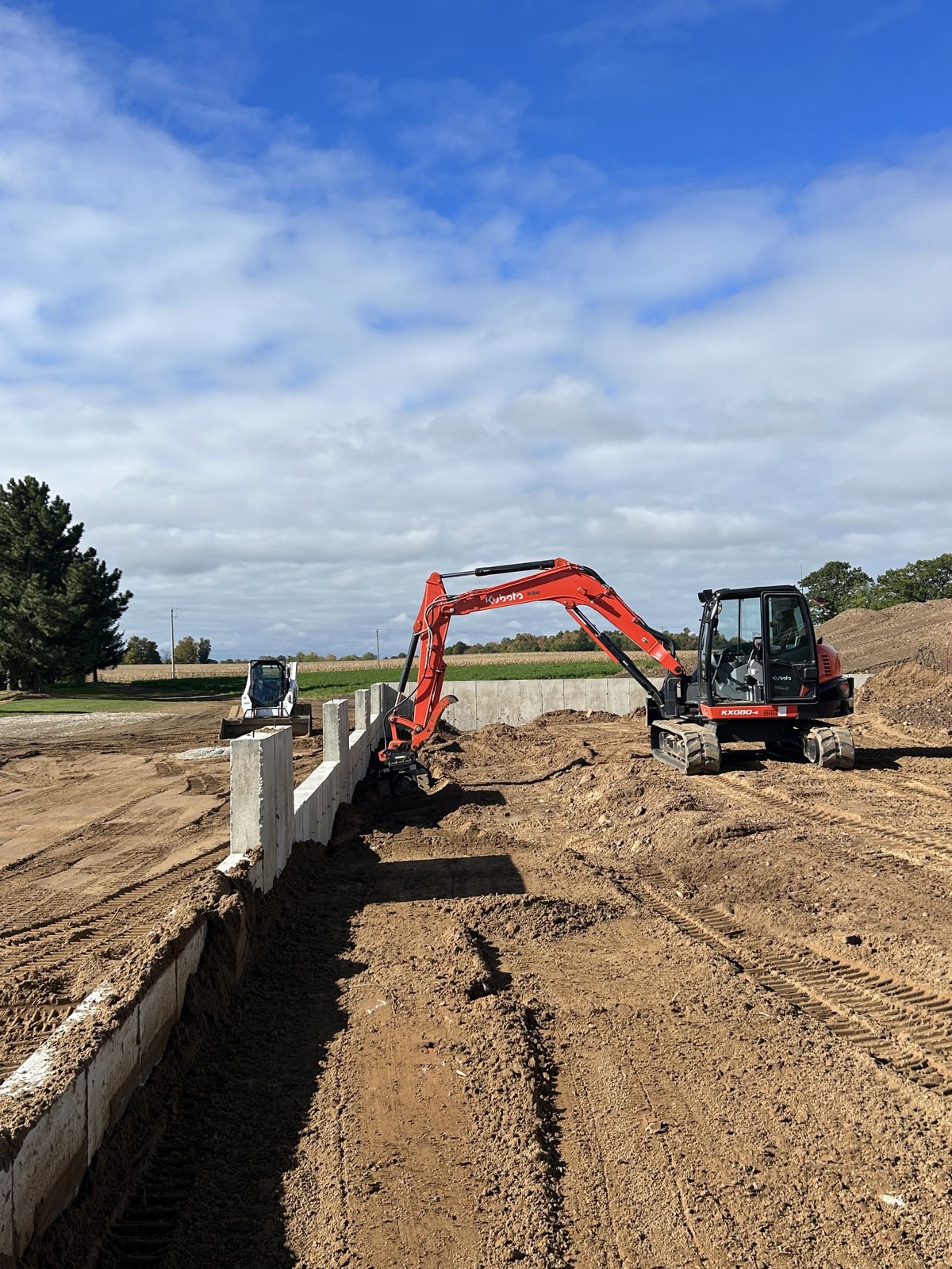 Kubota excavator digging a trench
