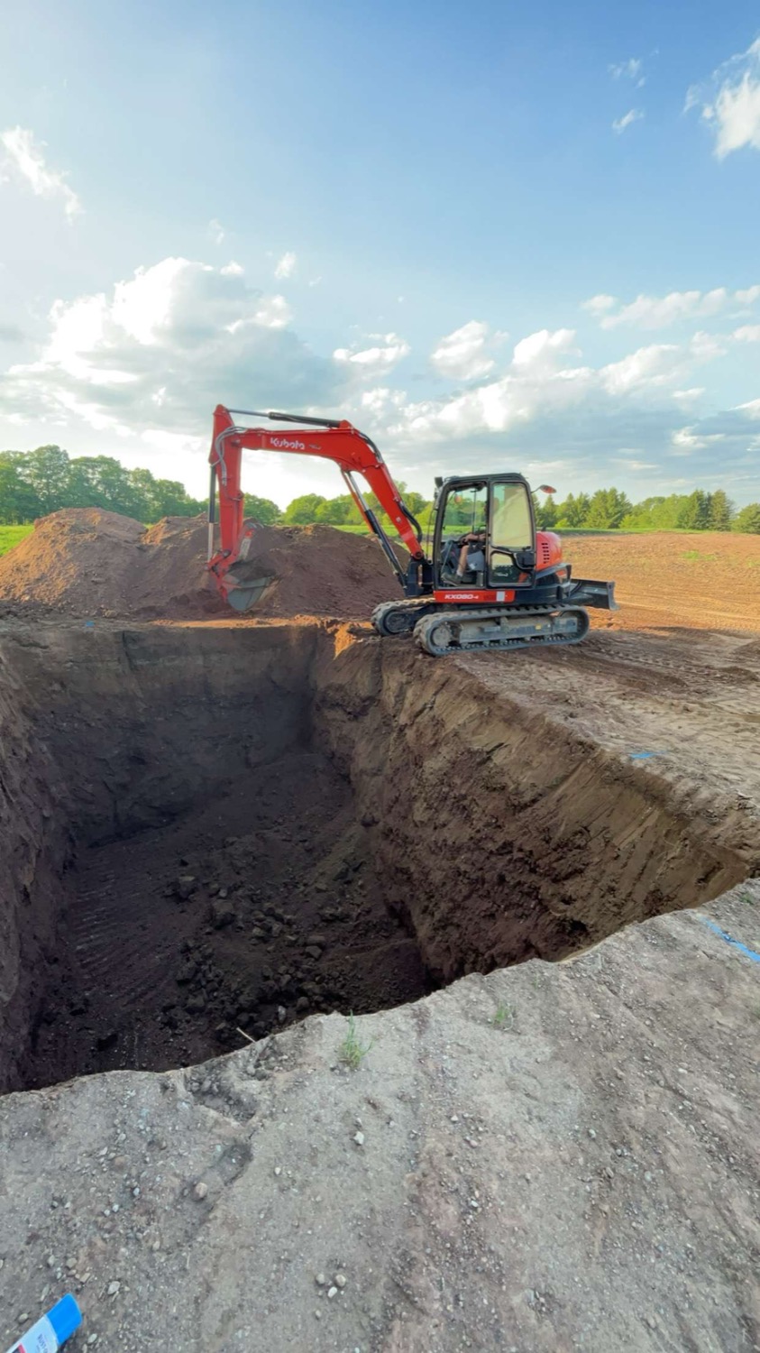 Kubota excavator on a large cut