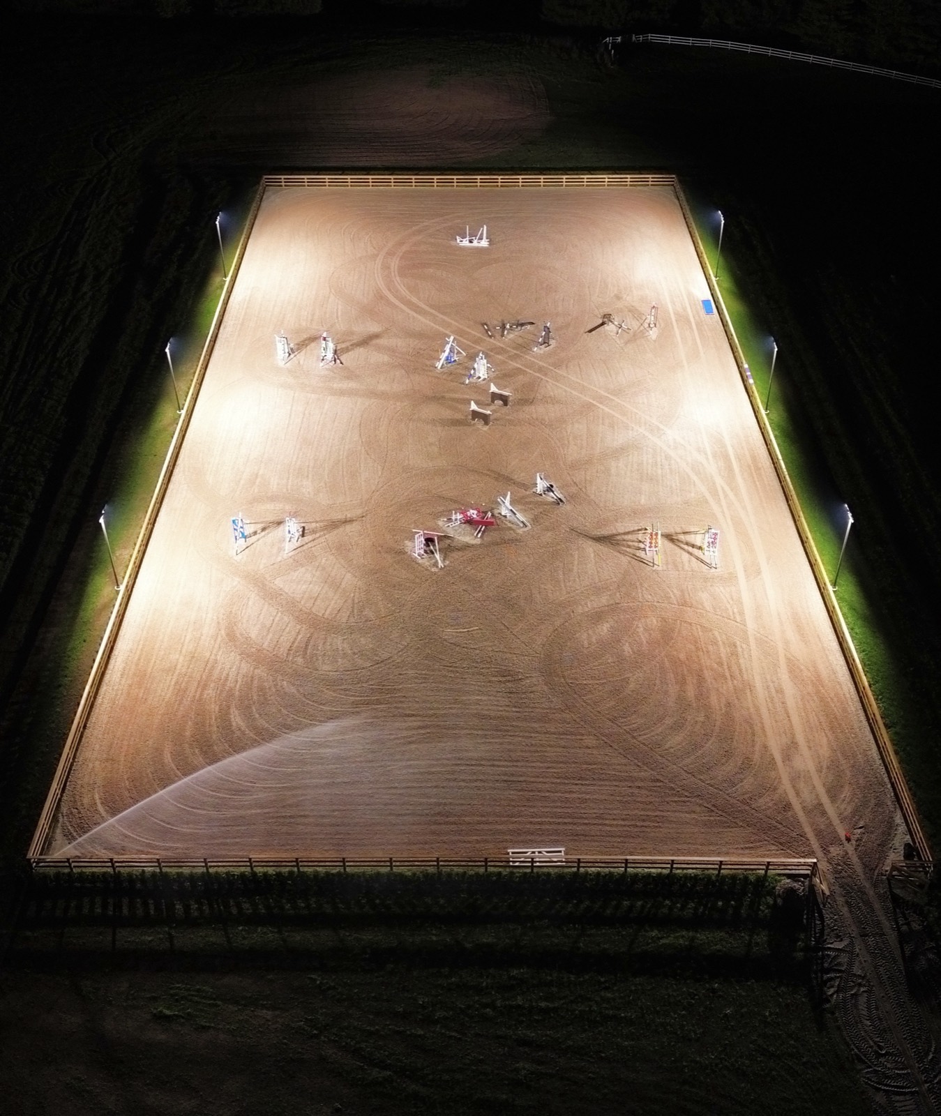 Floodlit equestrian riding arena at night