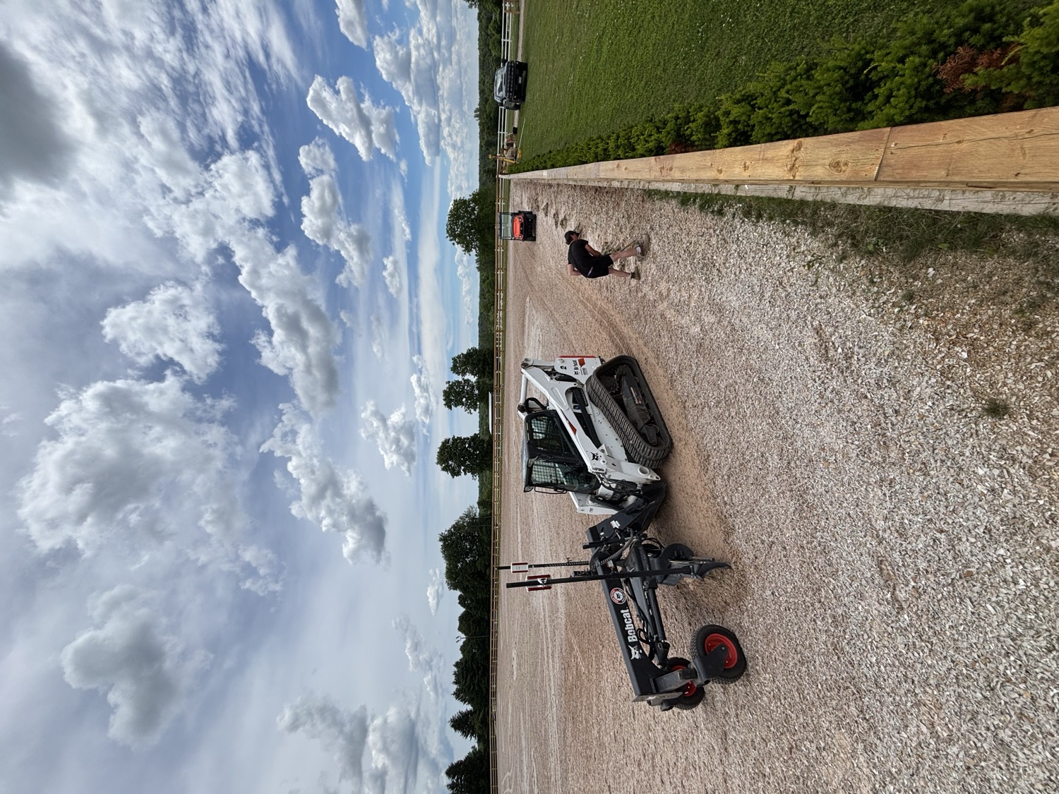 Outdoor riding arena with hedge border