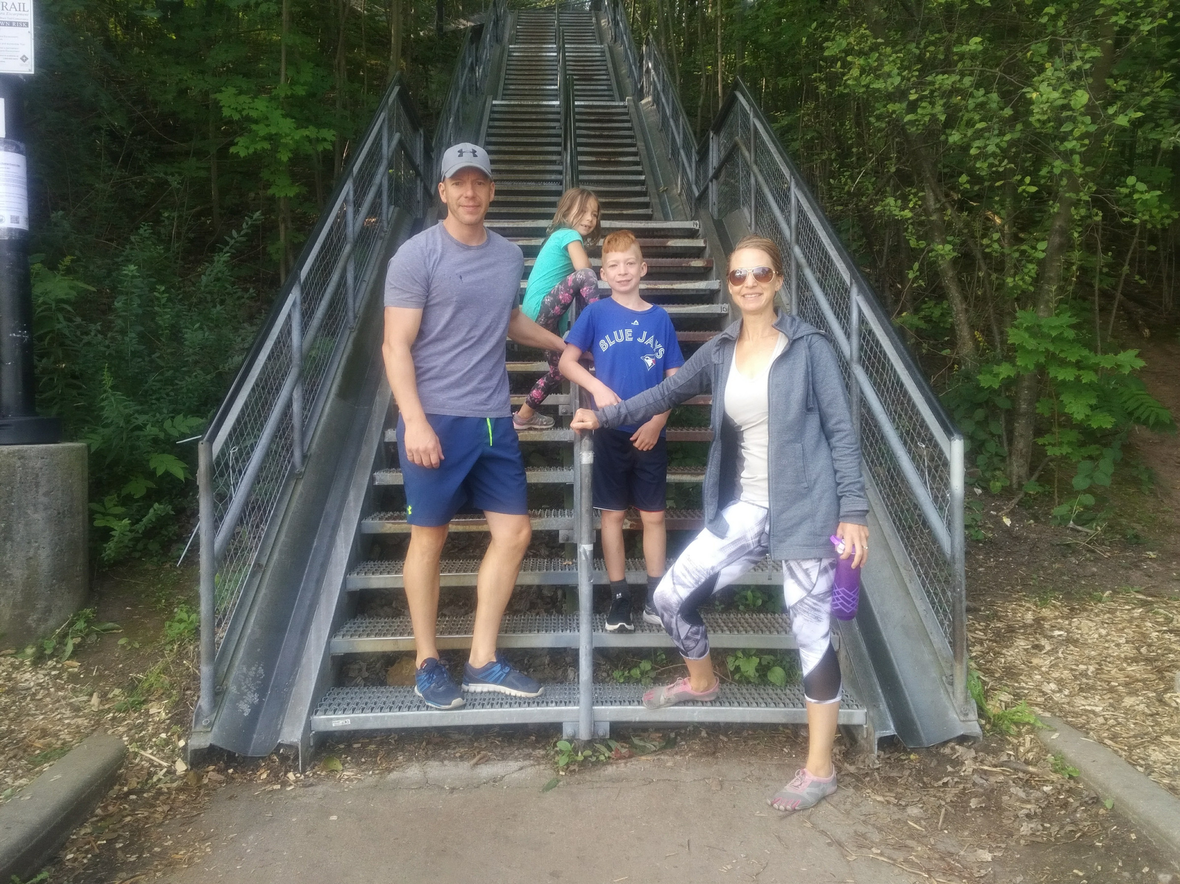 Kaley and her family on an outdoor staircase