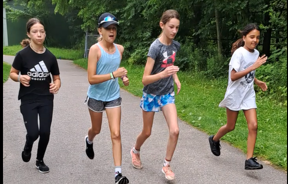 Young sprinters running on grass