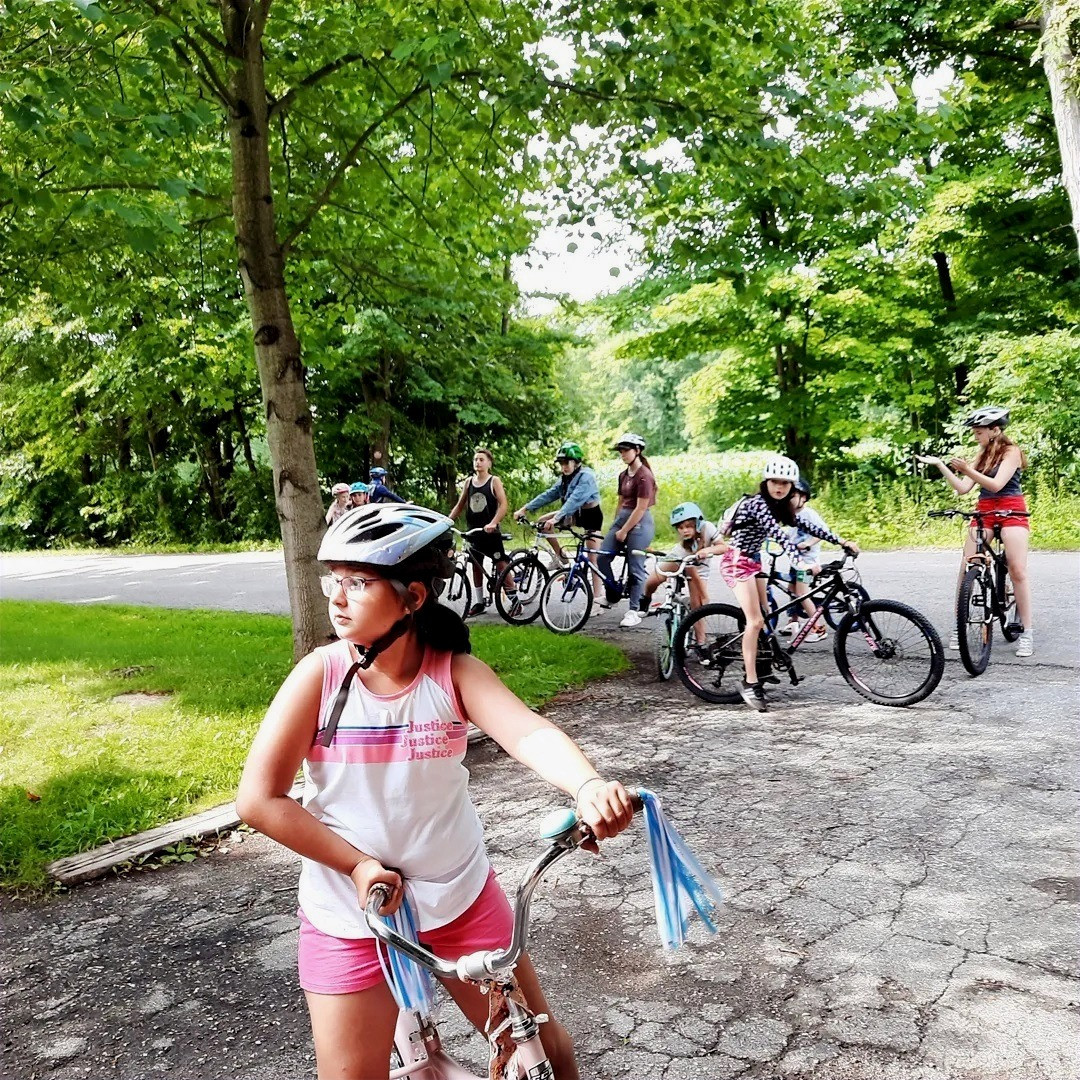 Campers riding bikes at the farm
