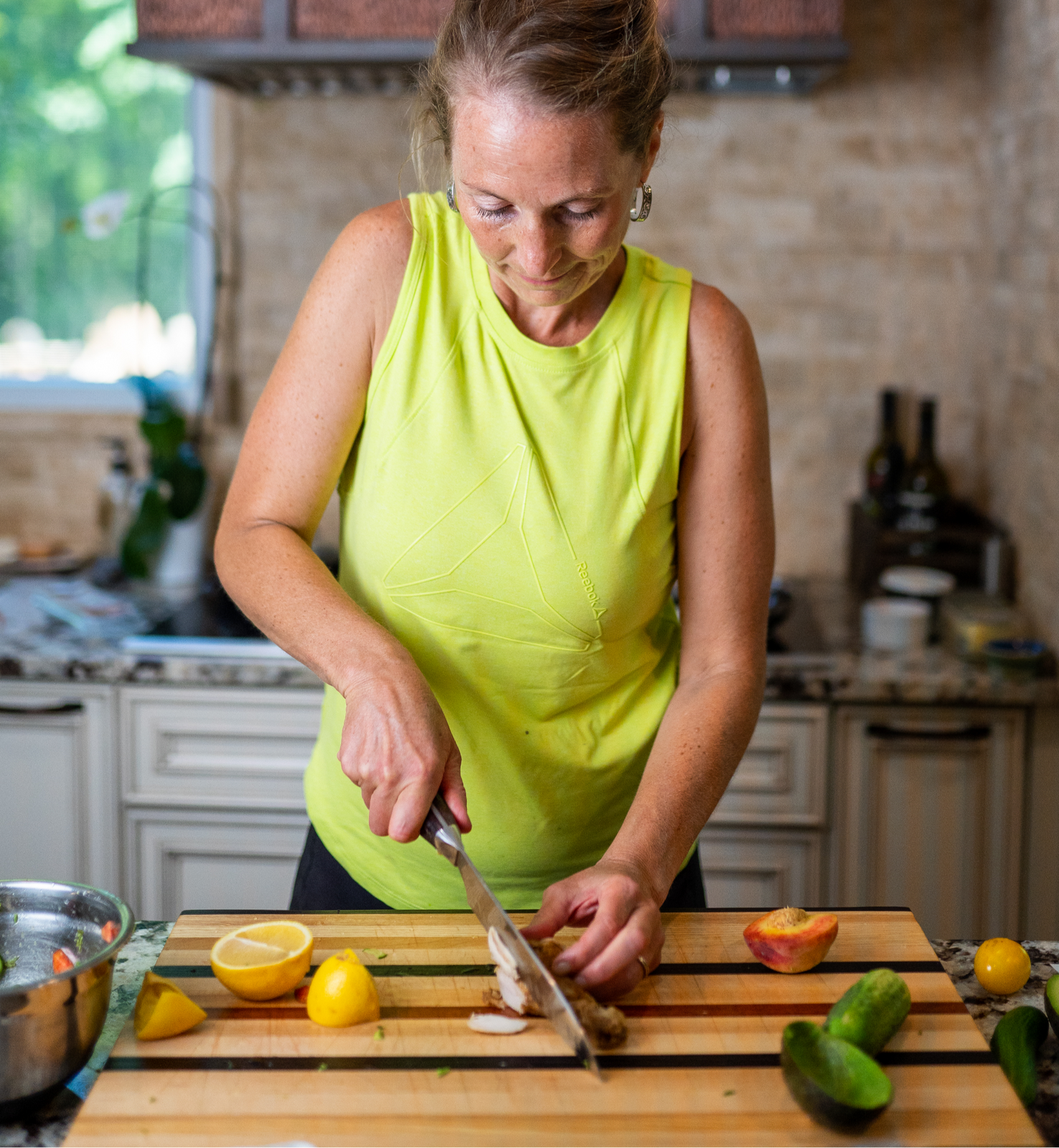 Kaley slicing lemons on a cutting board