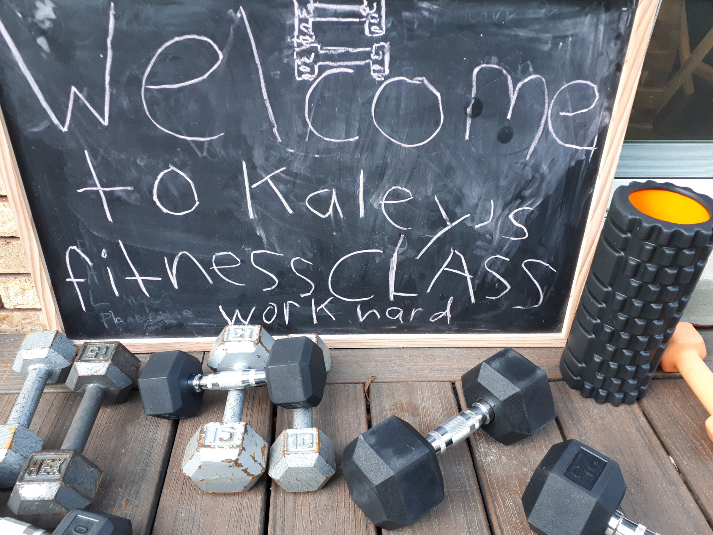 A chalkboard welcoming clients to Kaley's fitness class