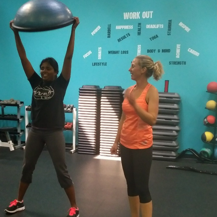 Kaley coaching a client with a weighted ball