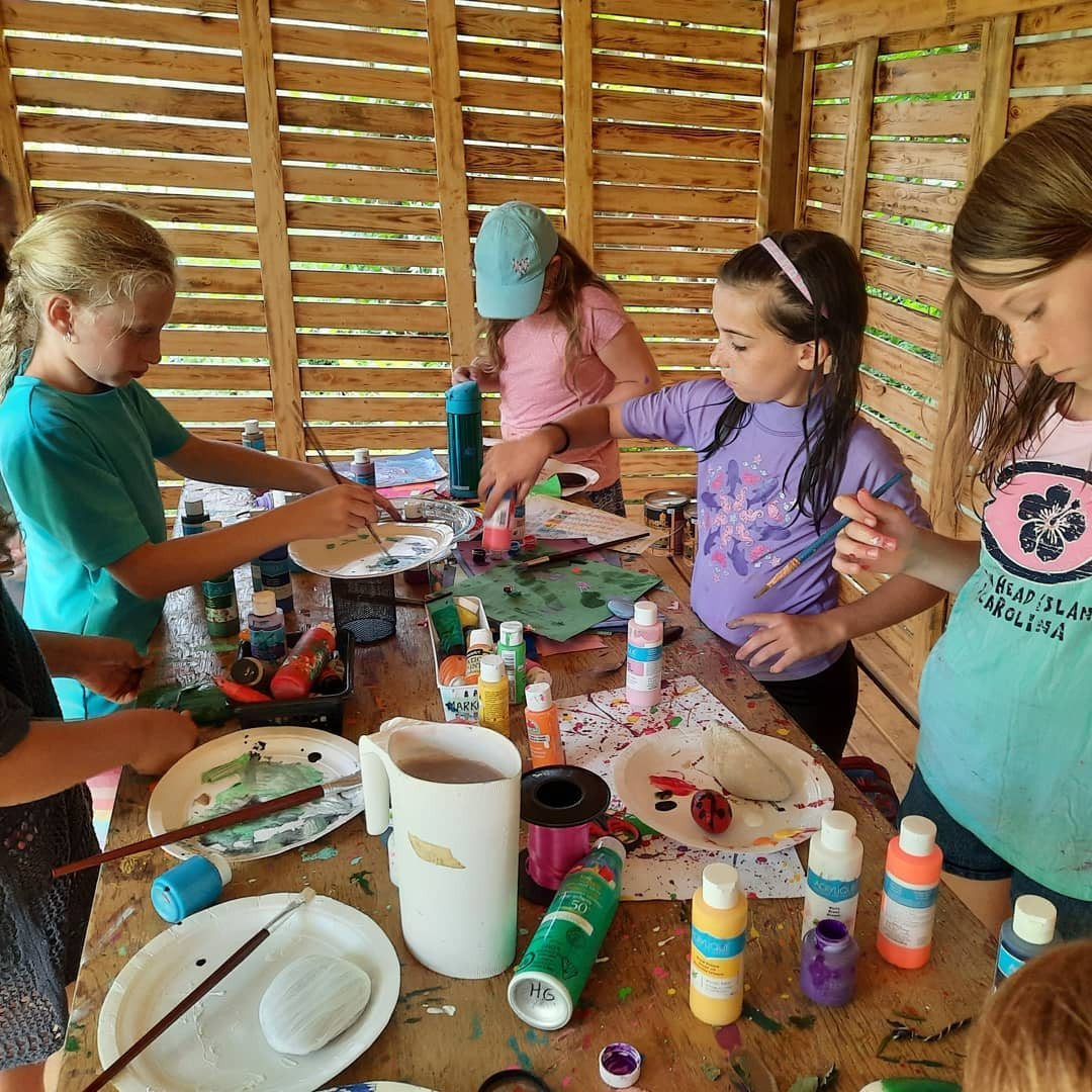 Campers cooking together at the farm