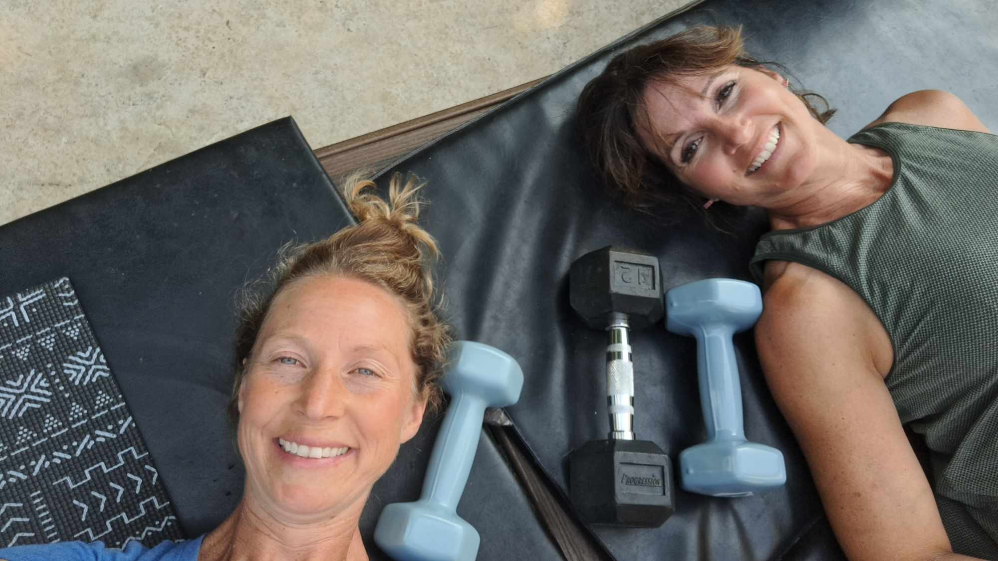 Kaley smiling with a set of dumbbells