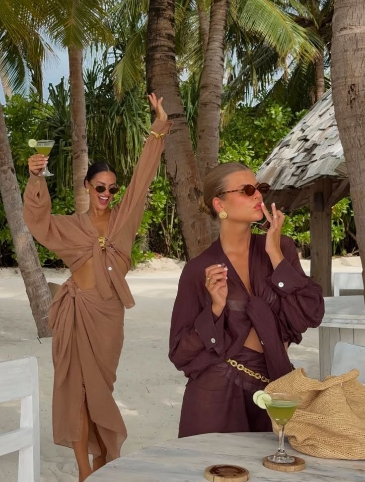 Two friends laughing on a beach trip