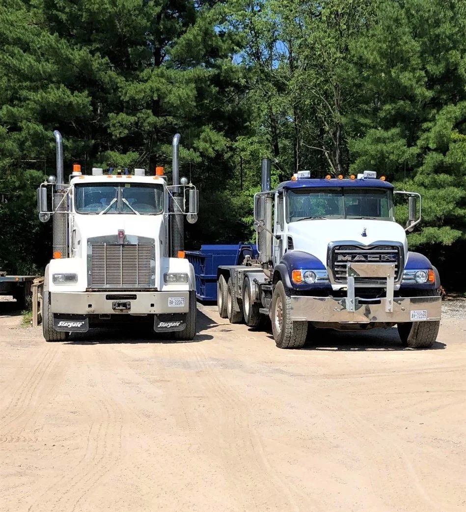 Two dump trucks parked side by side