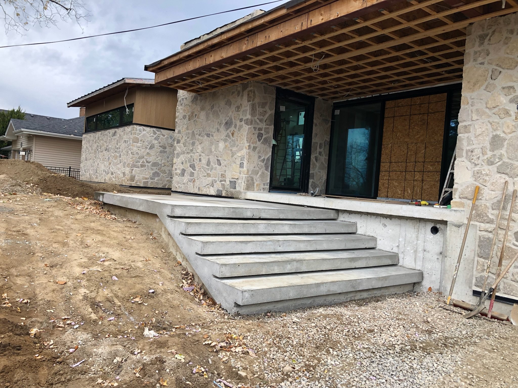 Wide concrete front steps at a stone house