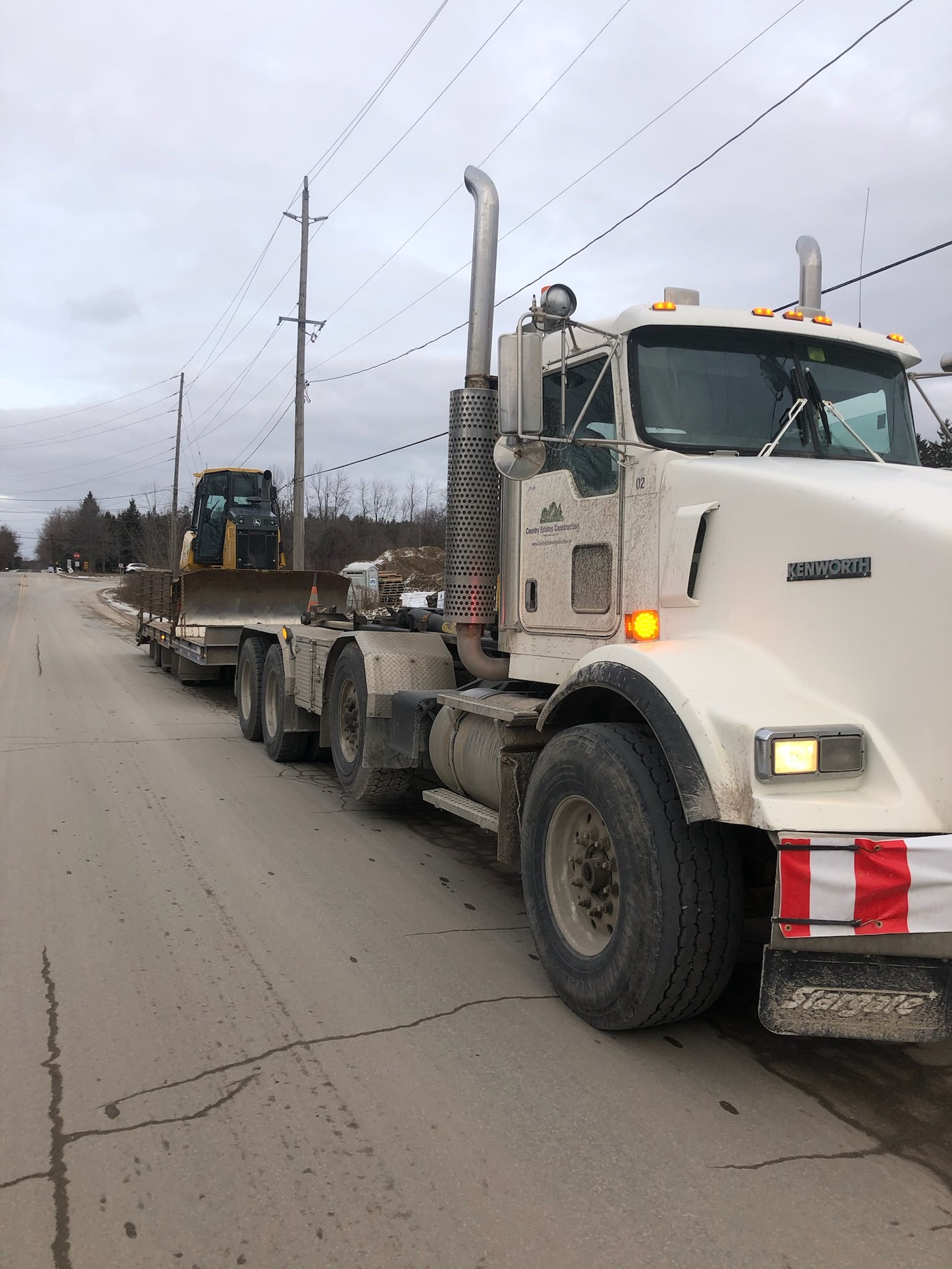 Tractor trailer pulling a float for moving equipment