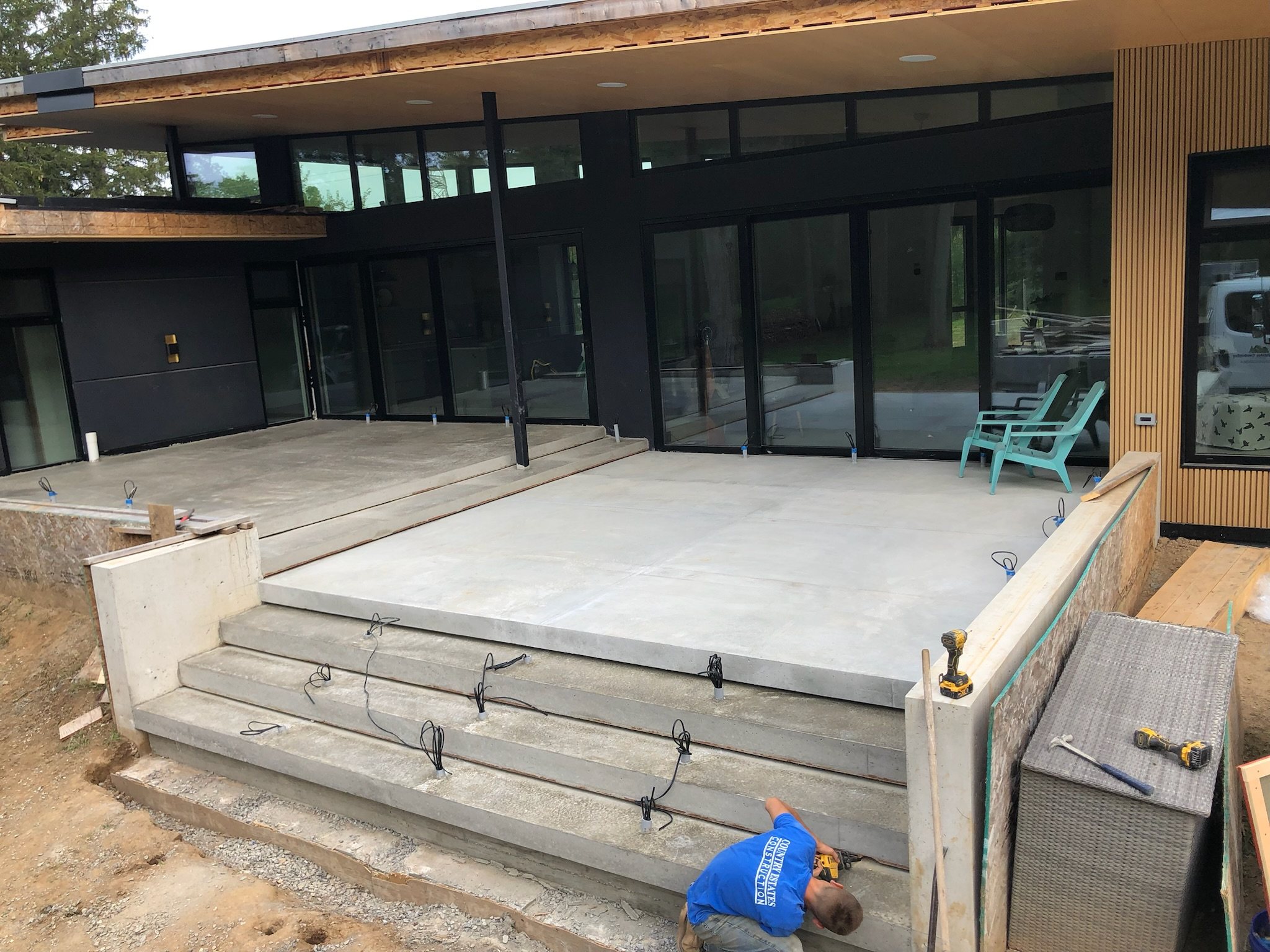 New concrete patio and wide concrete steps at a modern house